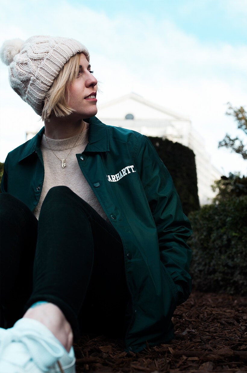 Matilda Anton in park wearing Carhartt coach jacket