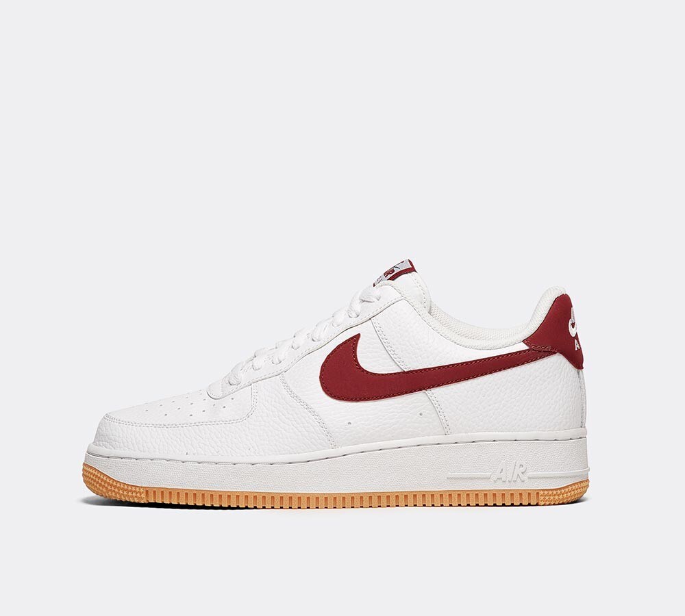 nike air force 1 trainers with red swoosh and gum sole