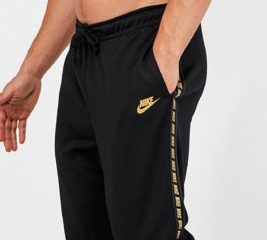 nike tape poly track pants gold